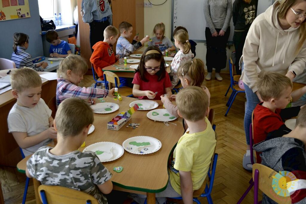 Dzieci siedzą przy stole i biorą udział w zajęciach o ekologii - Przedszkole Samorządowe Nr 2 Pod Słonkiem w Białymstoku