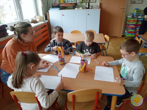 Siedzące studentki i dzieci przy stole - Przedszkole Samorządowe Nr 2 Pod Słonkiem w Białymstoku
