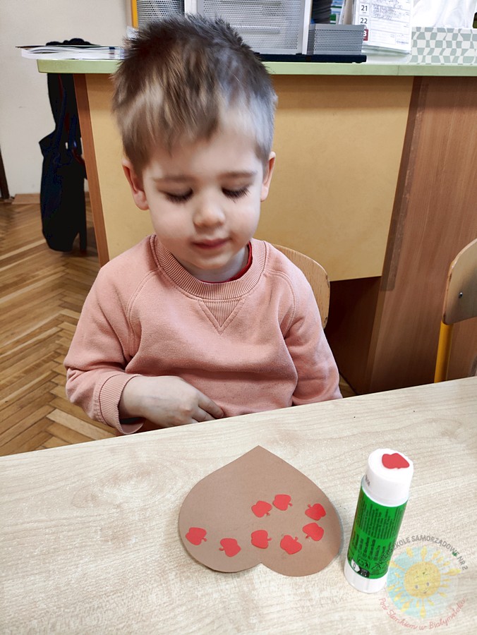 Siedzące dzieci przy stole i wykonują pracę plastyczną - Przedszkole Samorządowe Nr 2 Pod Słonkiem w Białymstoku