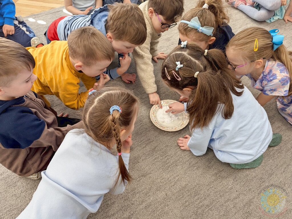 Siedzące dzieci na dywanie, które biorą udział w zajęciach - Przedszkole Samorządowe Nr 2 Pod Słonkiem w Białymstoku