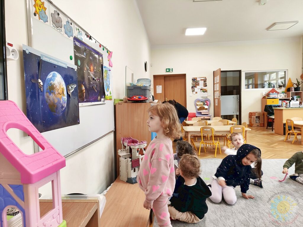 Siedzące dzieci na dywanie, które biorą udział w zajęciach - Przedszkole Samorządowe Nr 2 Pod Słonkiem w Białymstoku
